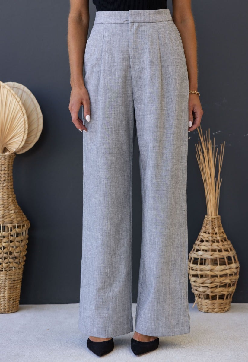 Kodi Pants in light grey, wide leg, mid-high waist, styled with chic accessories and a neutral background.