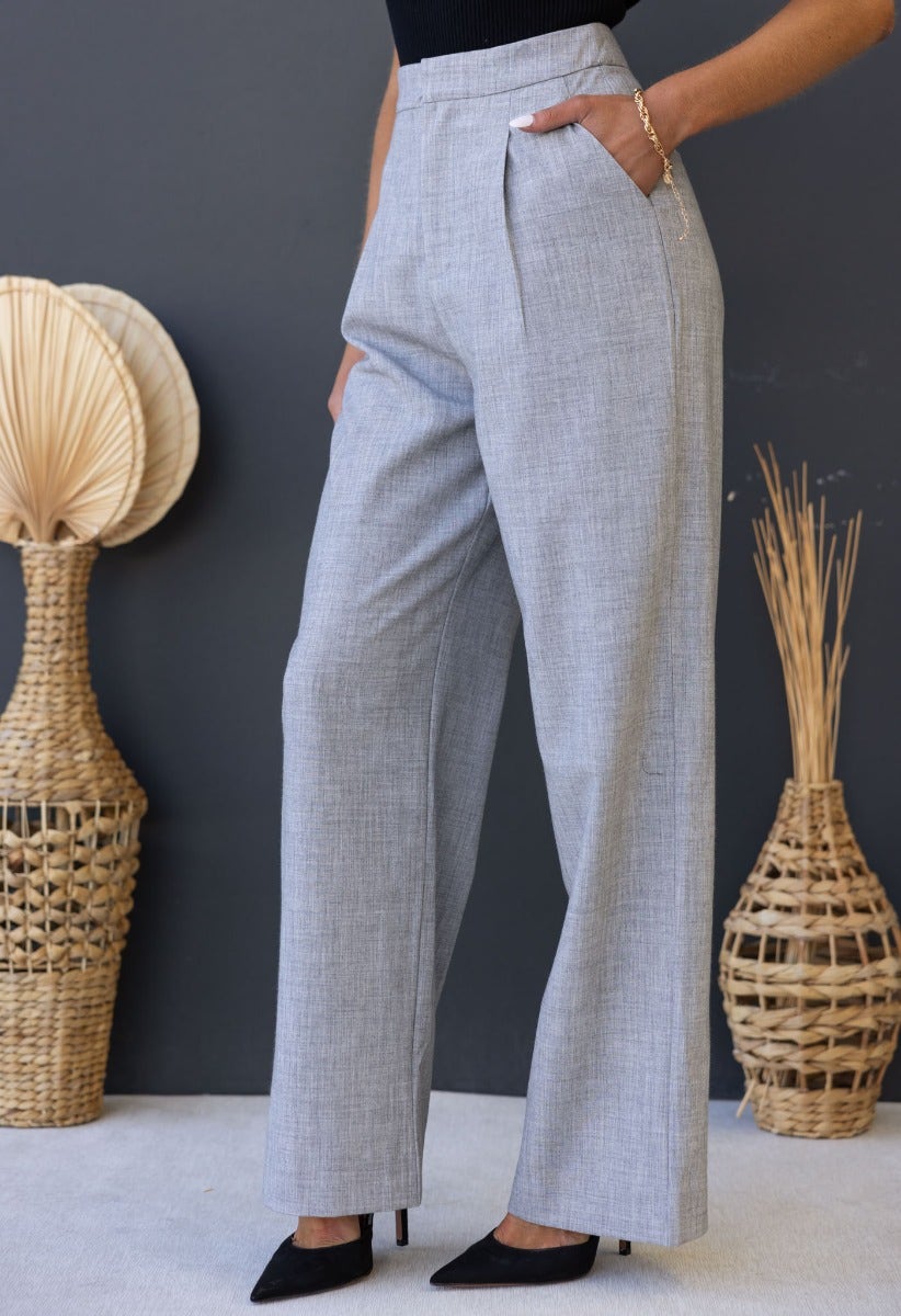 Stylish grey Kodi pants featuring a mid-high waist, wide legs, and pockets, perfect for a chic, modern look.