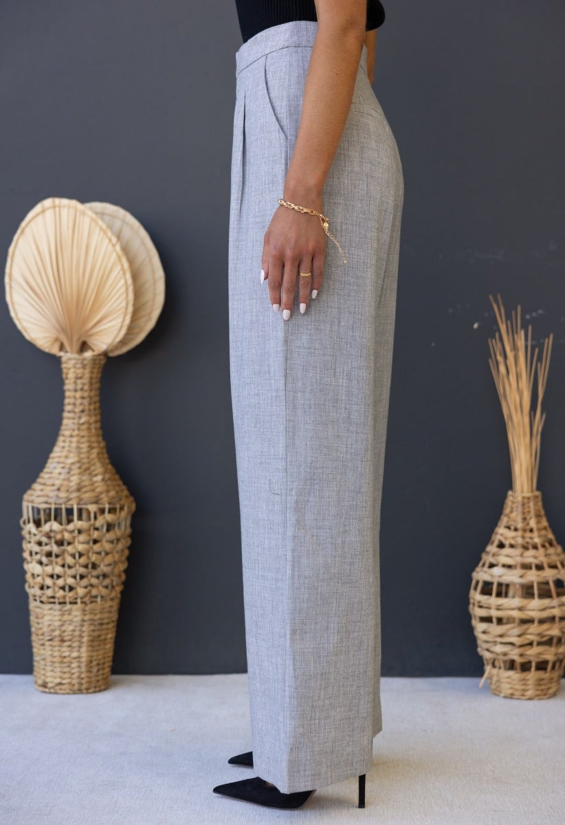 Side view of Kodi Pants in grey, featuring a mid-high waist, wide legs, and tailored fit.
