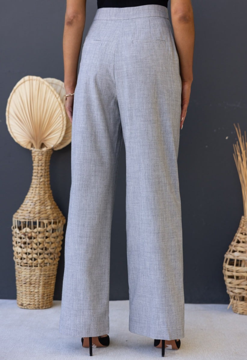 Back view of Kodi Pants, stylish mid-high waist dress pants with wide legs in a chic check pattern.