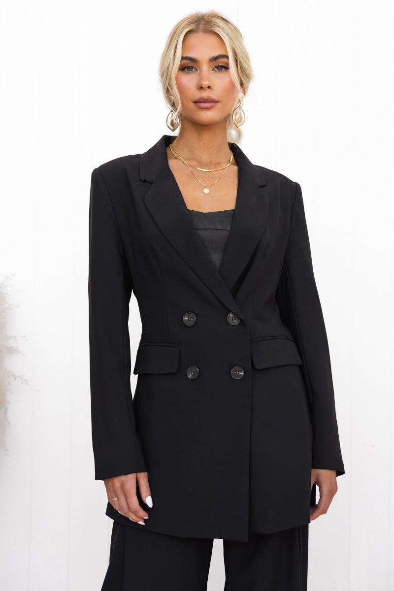 Estel Black Blazer featuring a double-breasted design, lapel collar, and faux pockets, styled elegantly for a chic look.
