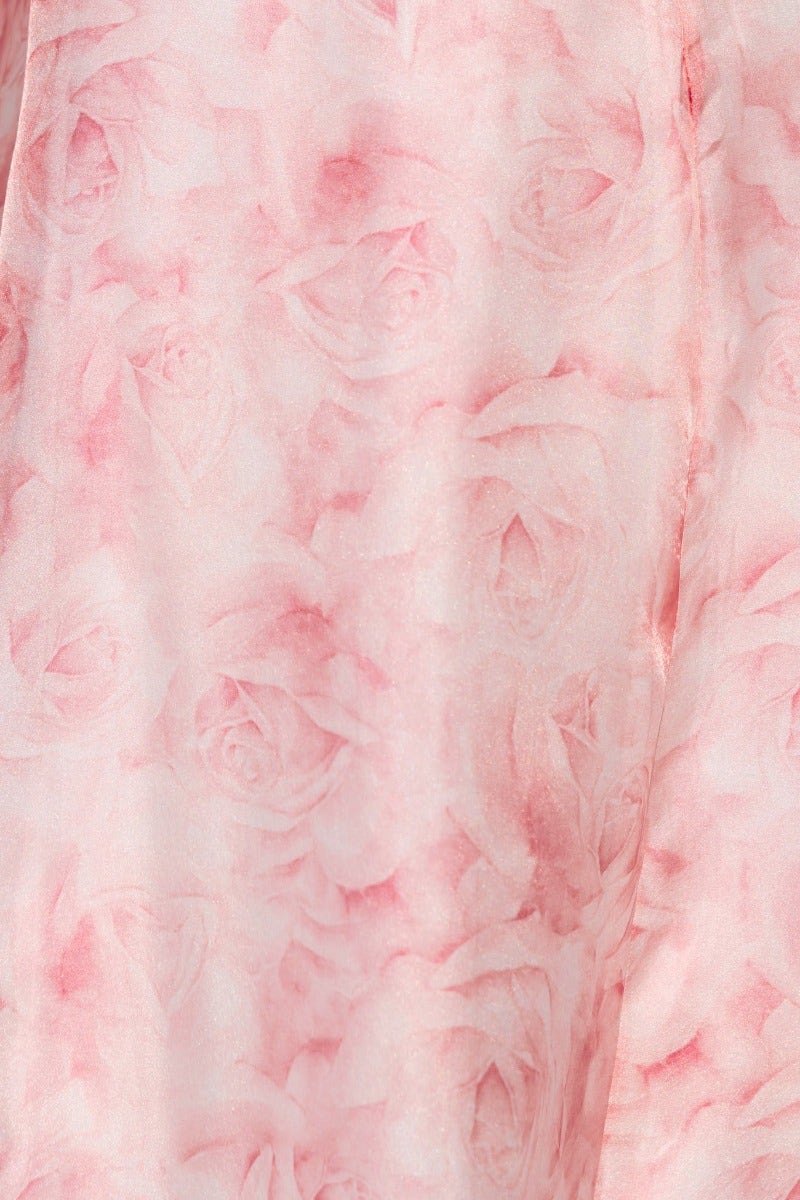 Floral print detail of the Qosta Midi Dress featuring soft pink roses on a lightweight fabric.