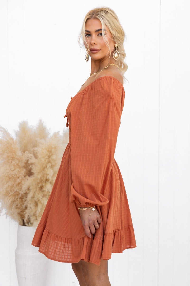 Elegant orange cotton getaway dress with off-shoulder styling and tie detail, perfect for summer outings.