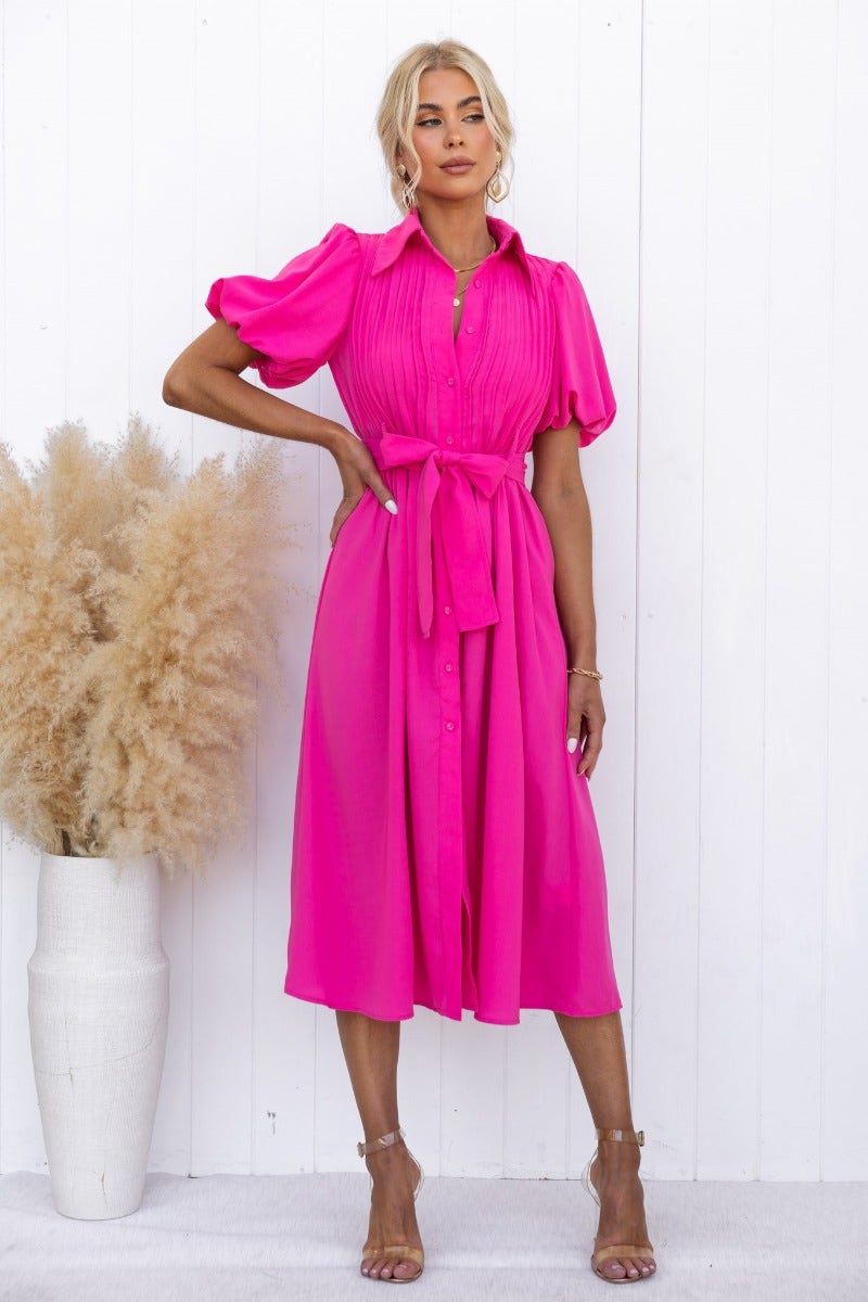 Bright pink Sorrento Midi Dress with high neckline, puff sleeves, and removable belt, displayed against a white backdrop.