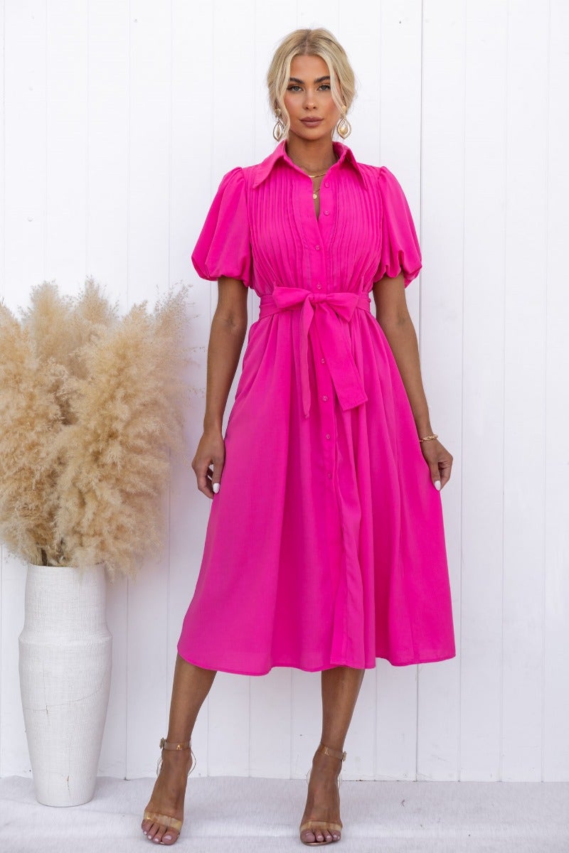 Bright pink Sorrento Midi Dress featuring a high neckline, button-up front, and removable fabric belt.