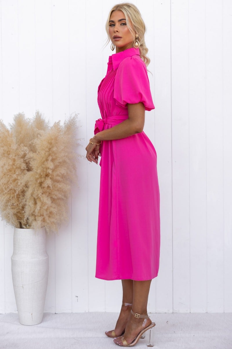 Sorrento Midi Dress in vibrant pink with high neckline, button-up front, and removable belt, styled against a white backdrop.