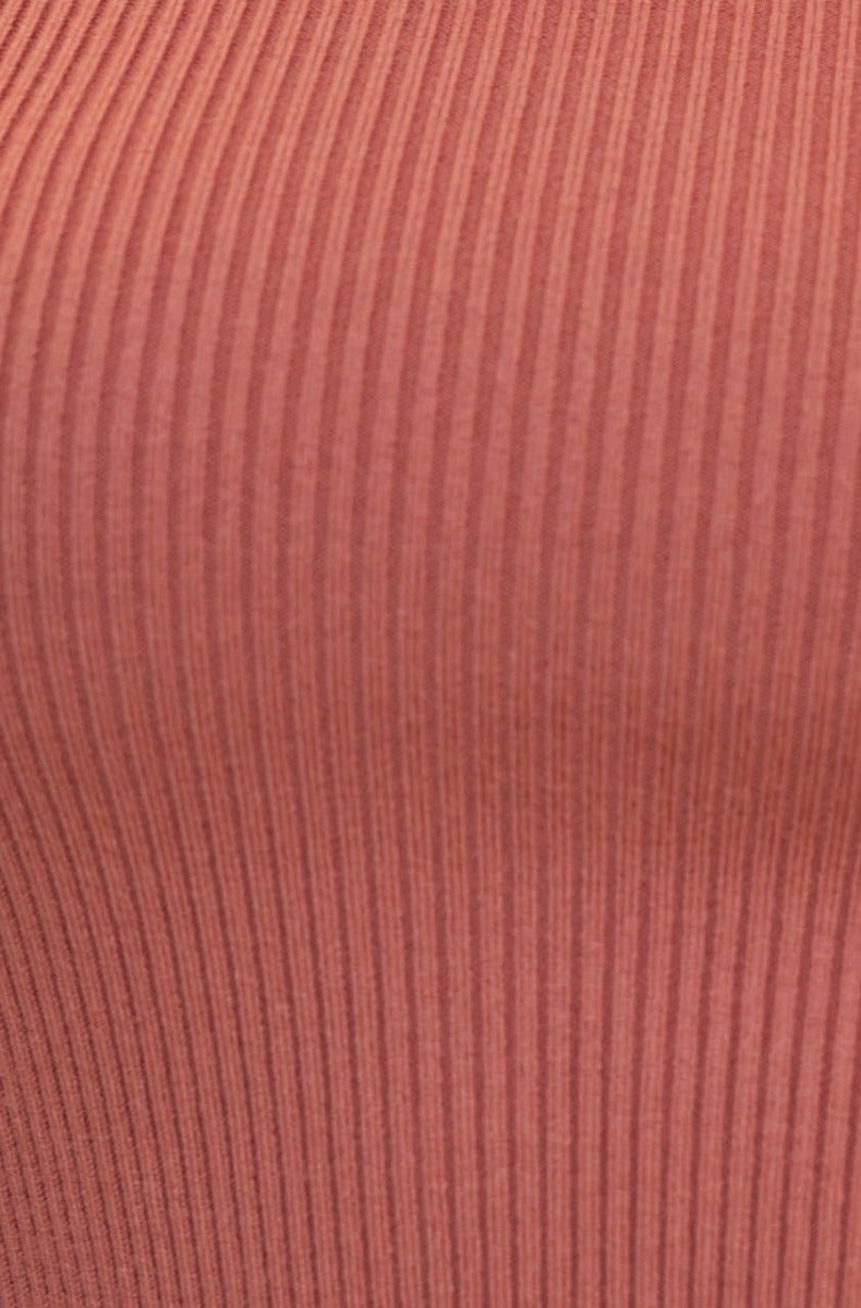 Close-up of ribbed knit texture in a soft rose color, showcasing stretch fabric of Ulina Midi Dress.