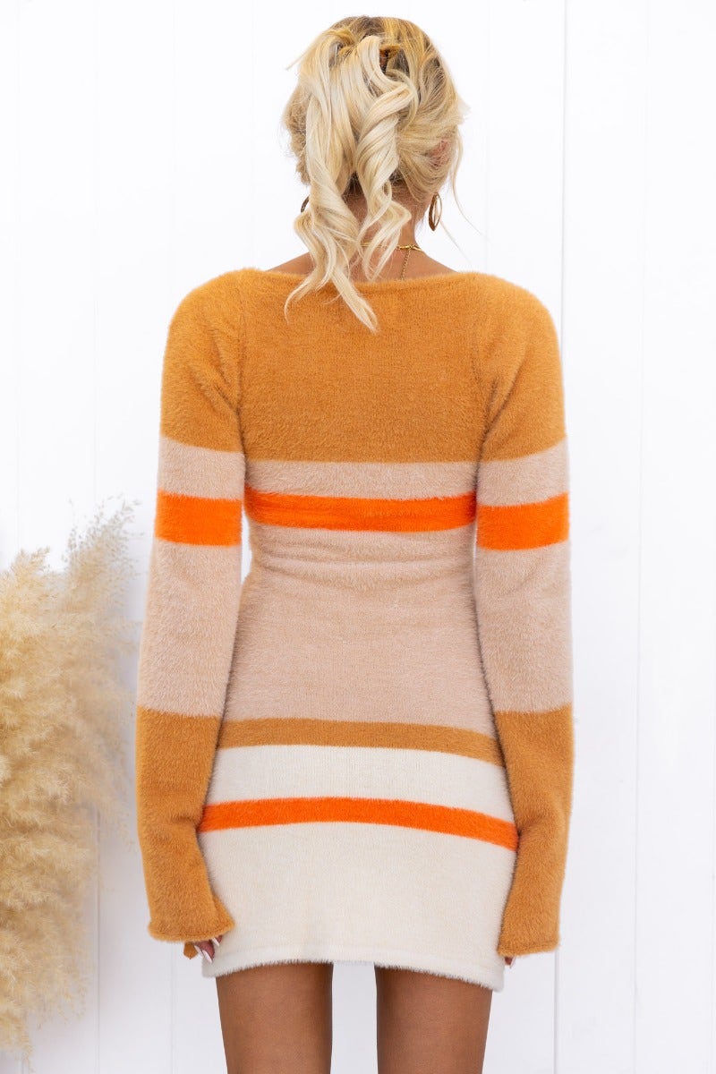 Back view of Tynan Dress in fluffy knit, featuring round neckline, flare sleeves, and vibrant color stripes.