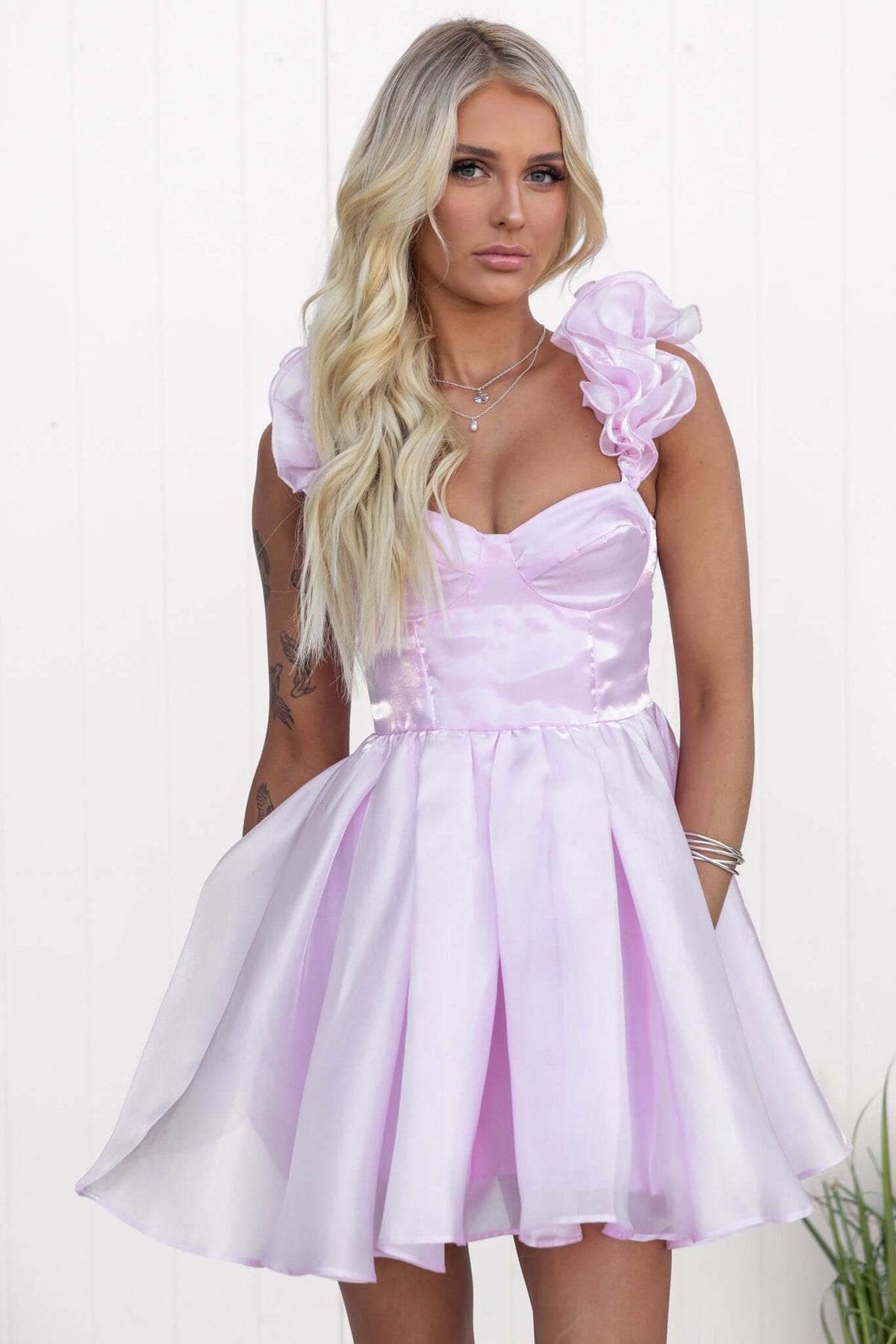 Ermia Dress in pastel pink with ruffle straps, featuring a fitted bodice and a flowy skirt, perfect for summer occasions.