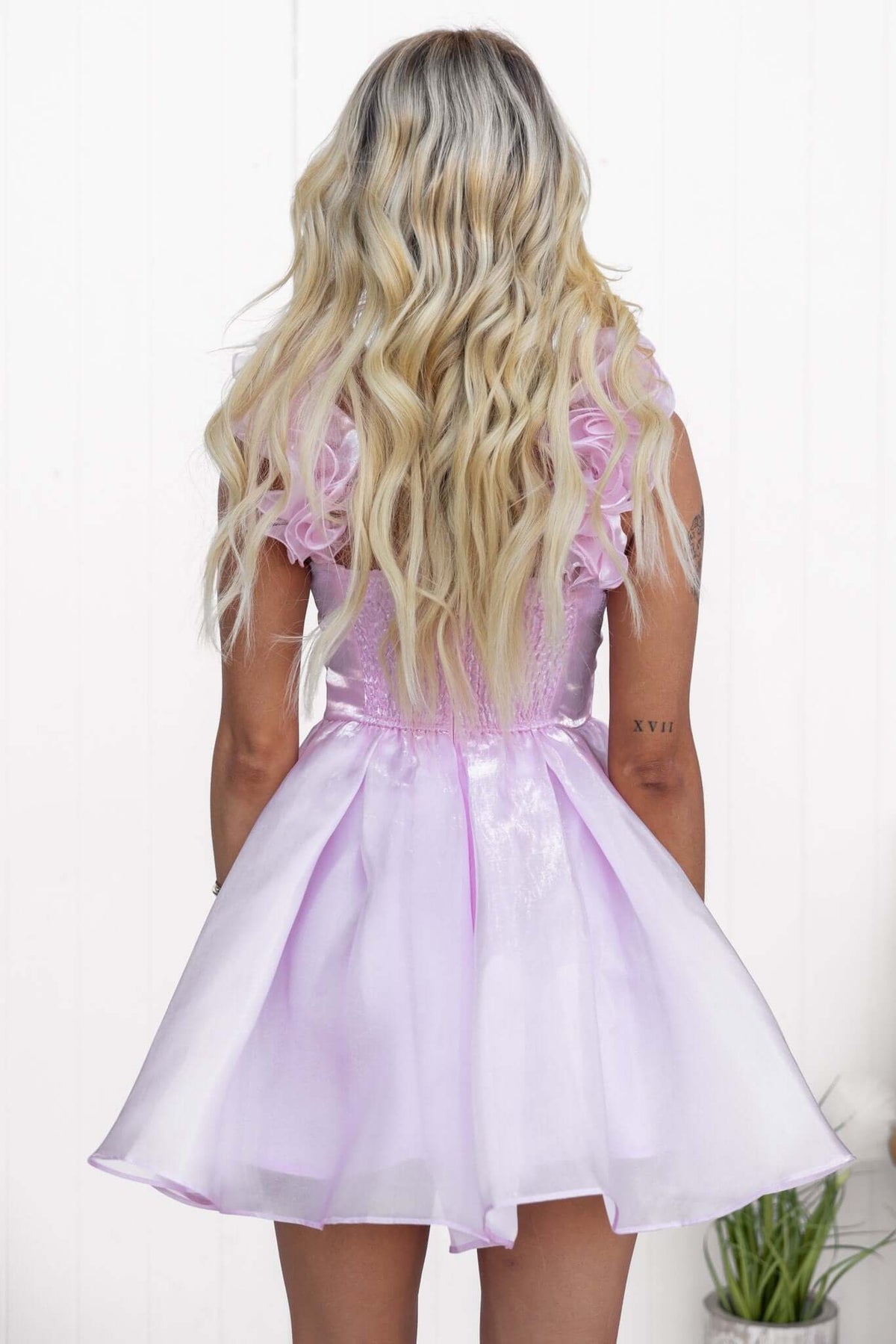 Back view of the Ermia Dress featuring ruffle straps and a shiny lilac chiffon finish.