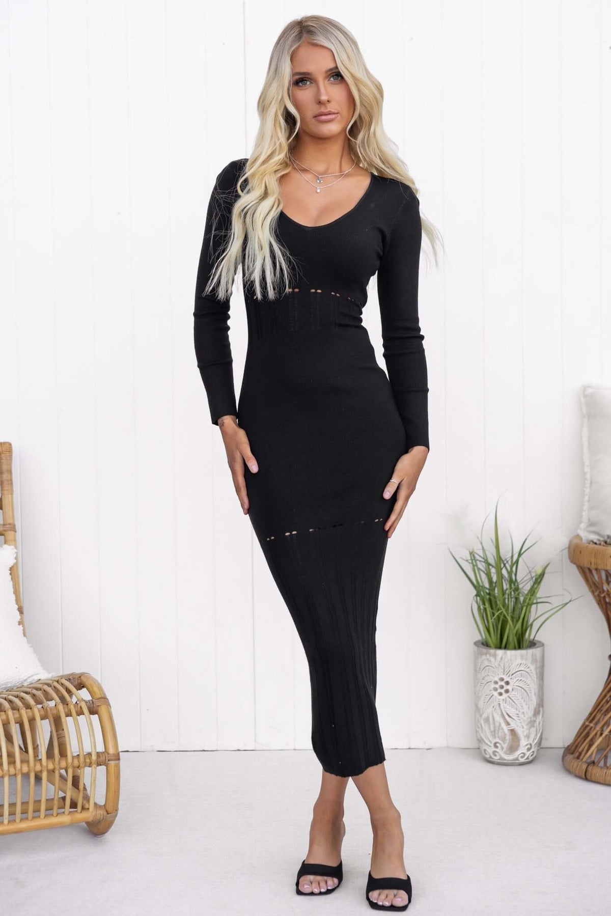 Valery Maxi Dress in black with scoop neckline and open weave detailing, styled on model in relaxed setting.
