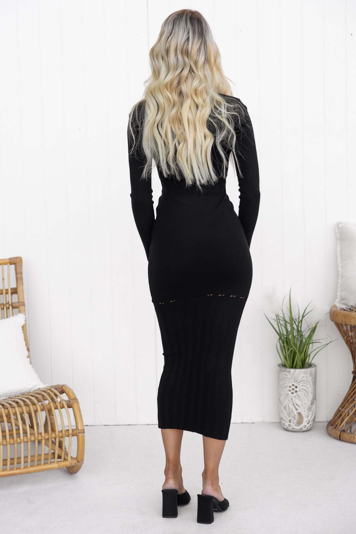 Valery Maxi Dress in black, featuring scoop neckline and open weave detailing, shown from the back with stylish heels.