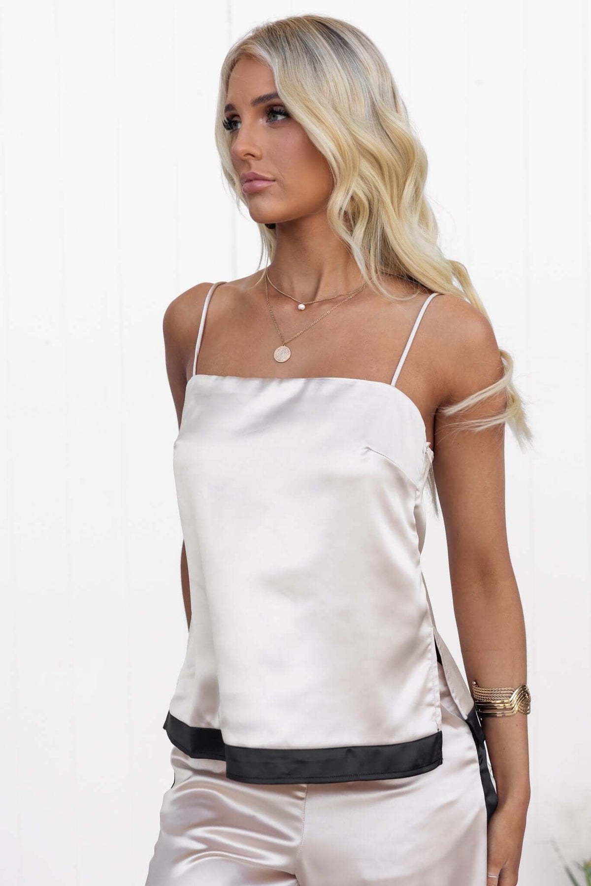 Stylish Tanaya Top featuring adjustable straps, side split, and satin look, worn by a model.
