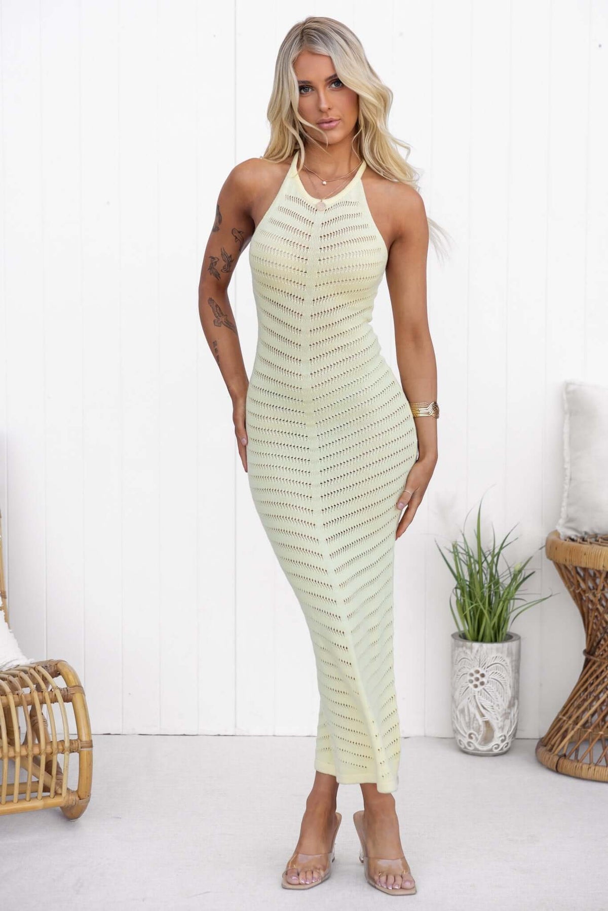 Ventura Maxi Dress featuring high neckline, silver ring detail, and an open weave design in soft green color.