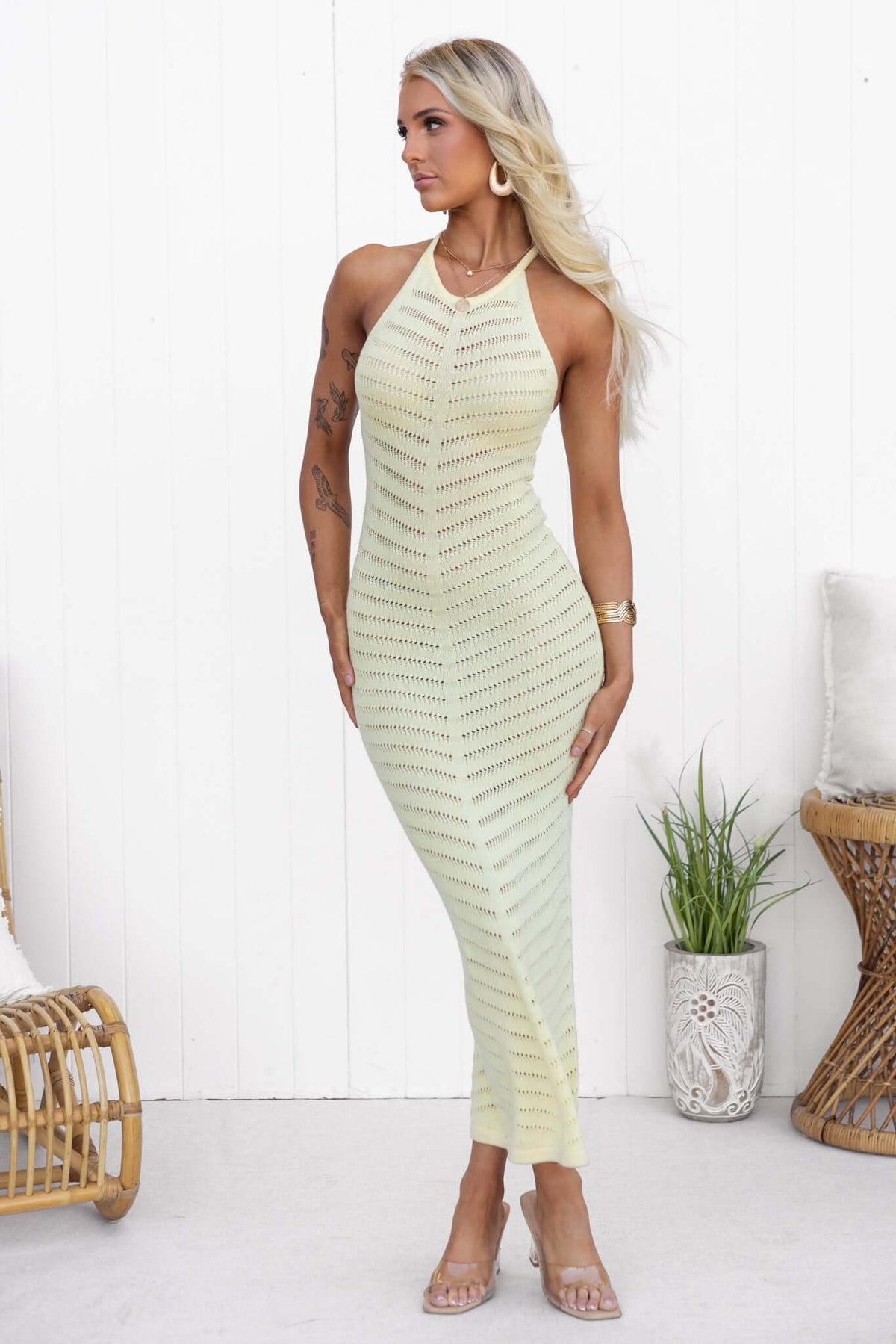 Model wearing the Ventura Maxi Dress, featuring a high neckline and open weave design, with a stylish ring detail at the back.