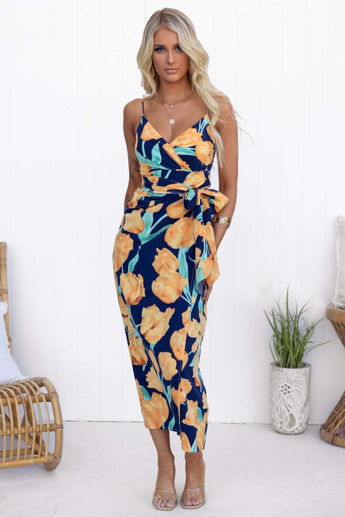 Navy Diri maxi dress with floral print, adjustable straps, and wrap tie detail, perfect for summer style.