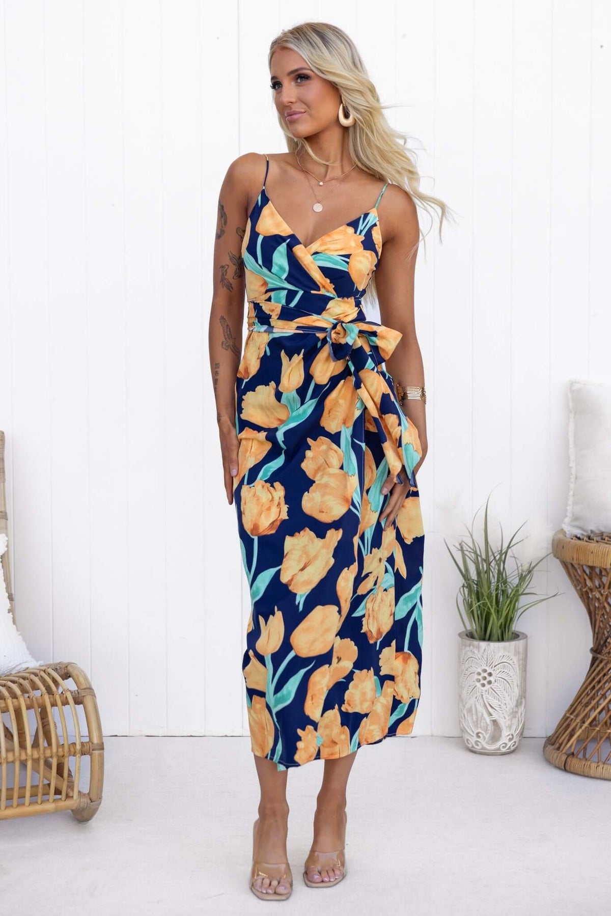 Navy floral Diri maxi dress featuring adjustable straps and wrap tie, perfect for casual summer outings.