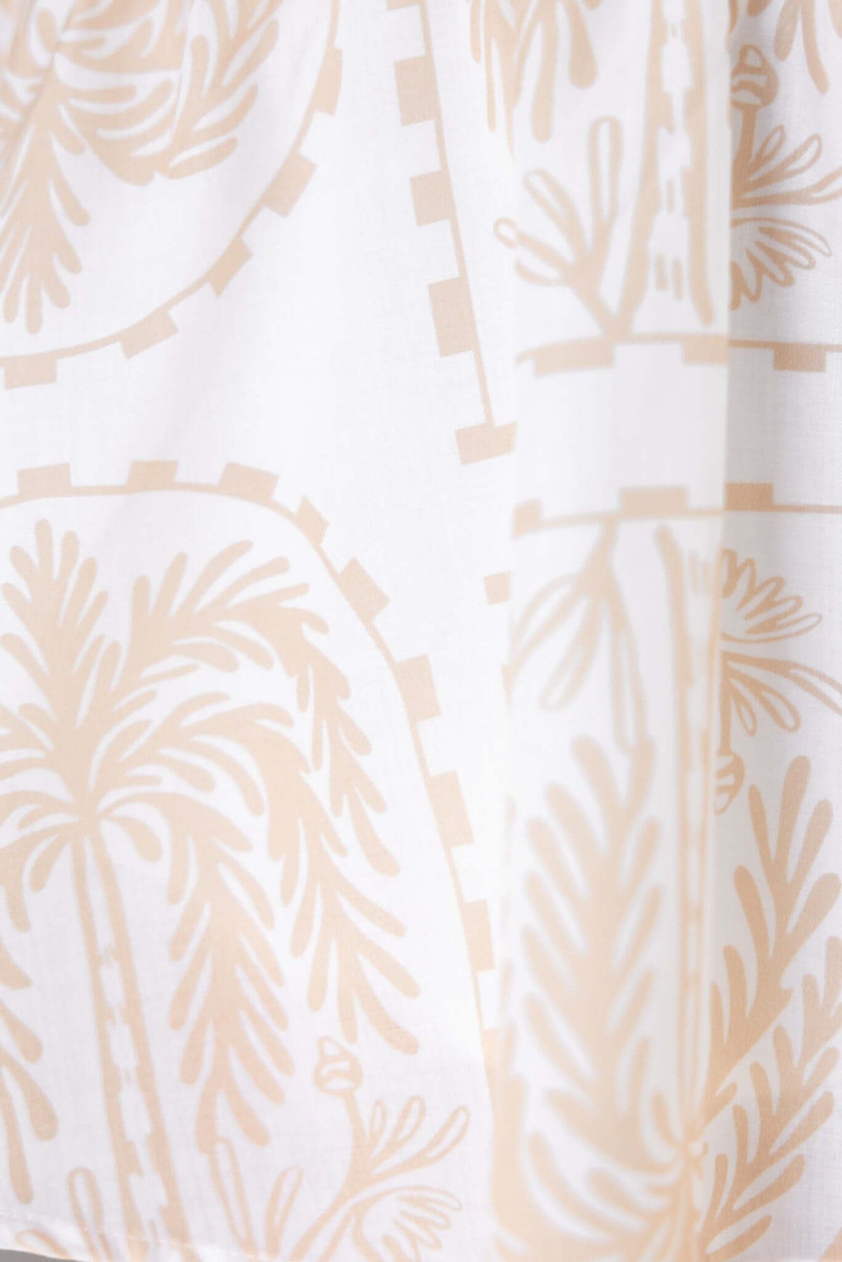Melfi Dress fabric close-up featuring a light palm leaf pattern in soft beige on white background.