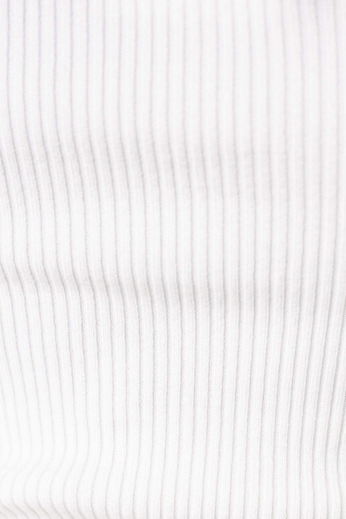 Close-up of ribbed knit fabric in white, showcasing the texture and stretch of the material.