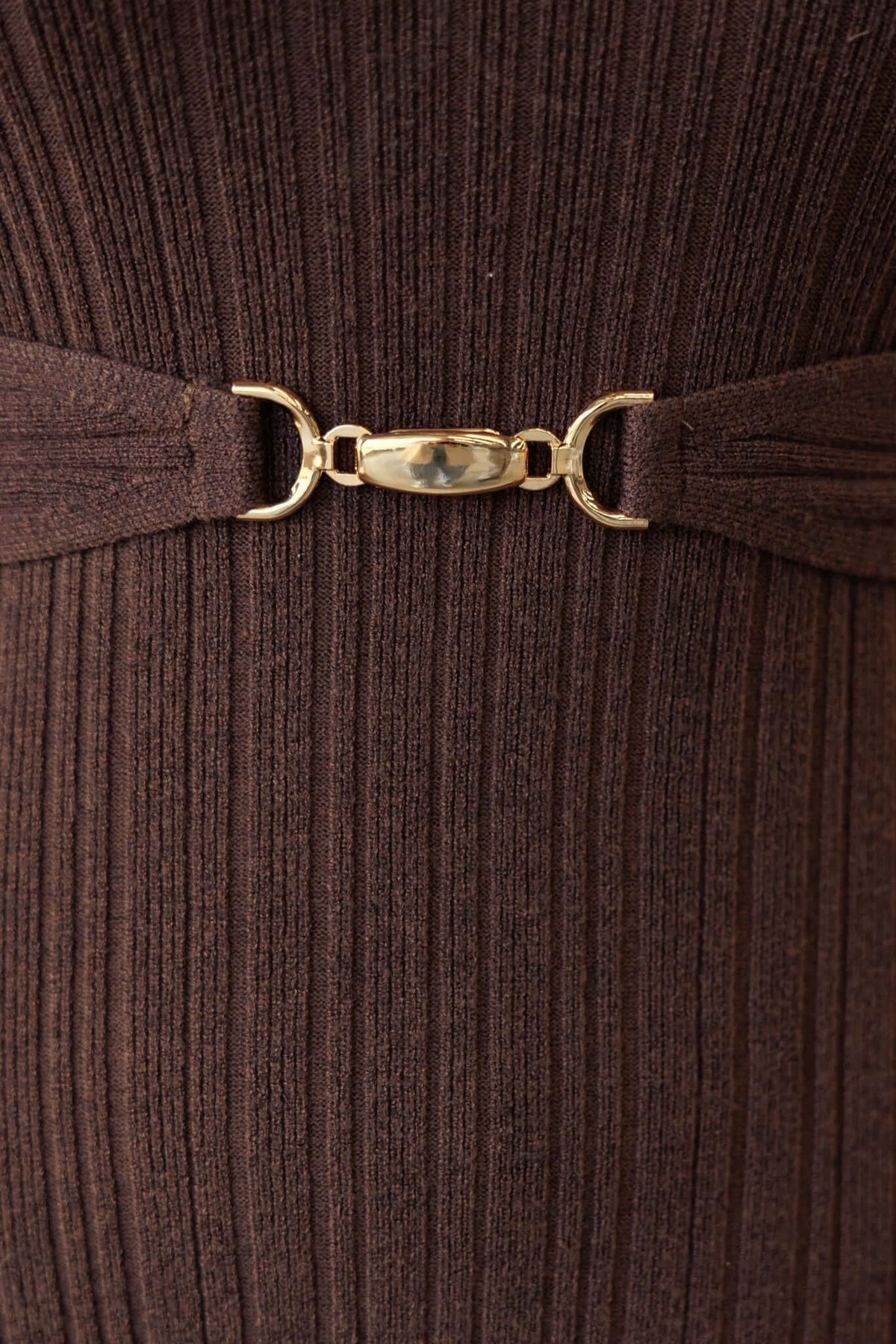 Close-up of the buckle detail featuring gold hardware on a ribbed knit top, highlighting the stylish design of the Burling Top.