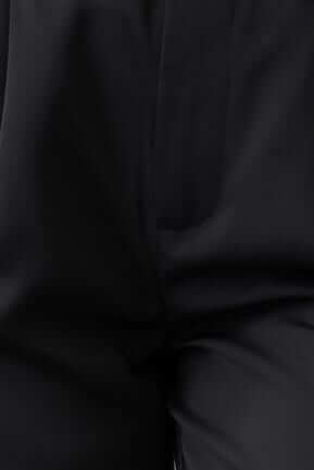 Close-up view of Hammond Pants in black, featuring mid-high waist, pockets, and a removable belt.