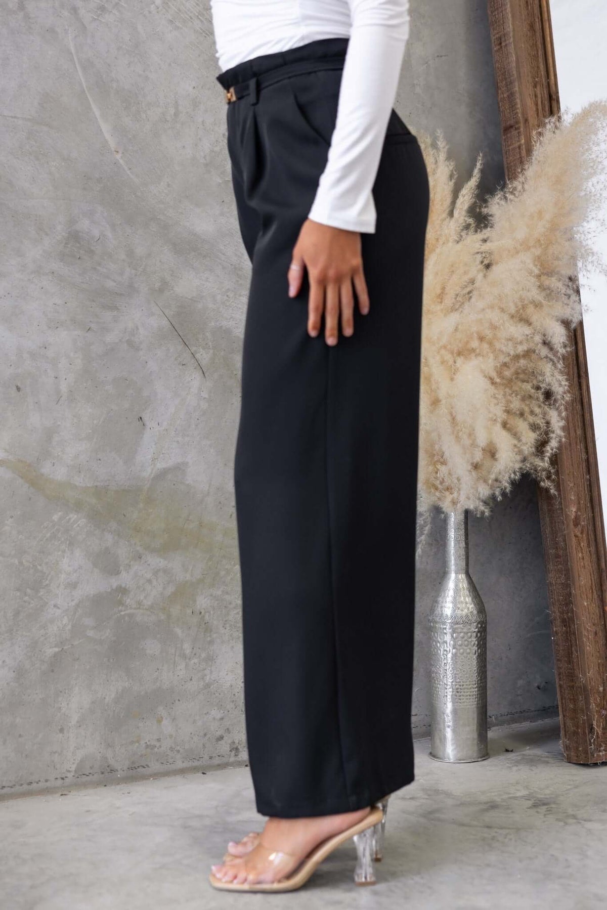 Side view of Hammond Pants in black with mid-high waist, removable belt, and pockets.