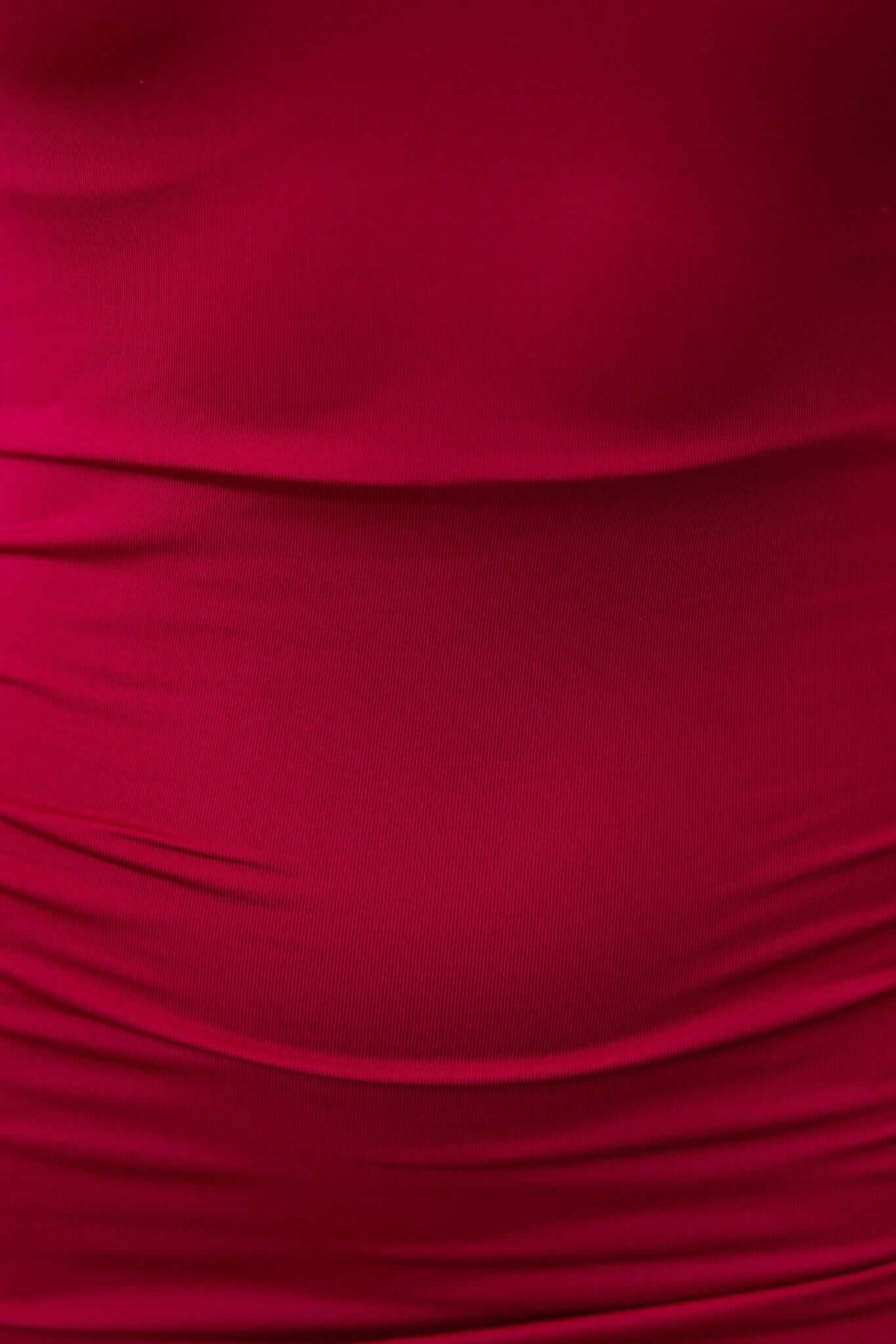 Close-up of Esha Maxi Dress in rich red, highlighting the textured, stretchy fabric and smooth silhouette.