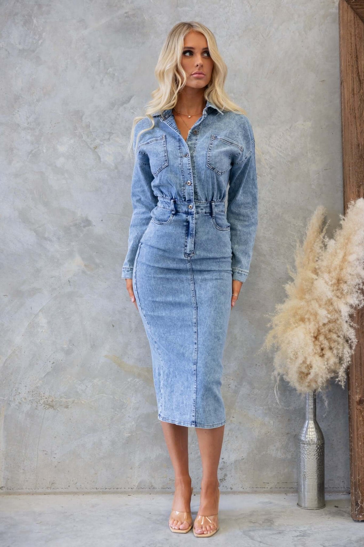 Stamford Denim Midi Dress featuring a button-up design, pockets, and a split back for a stylish, fitted silhouette.