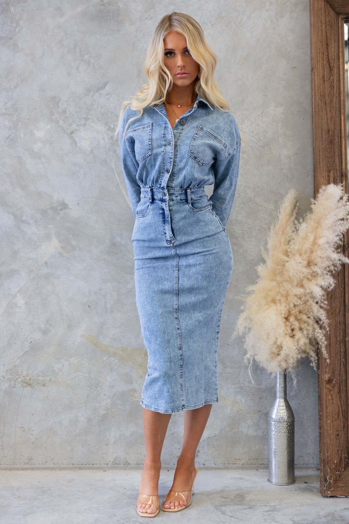 Stamford Denim Midi Dress featuring a button-up design, collar, and back split with a fitted silhouette in light blue denim.