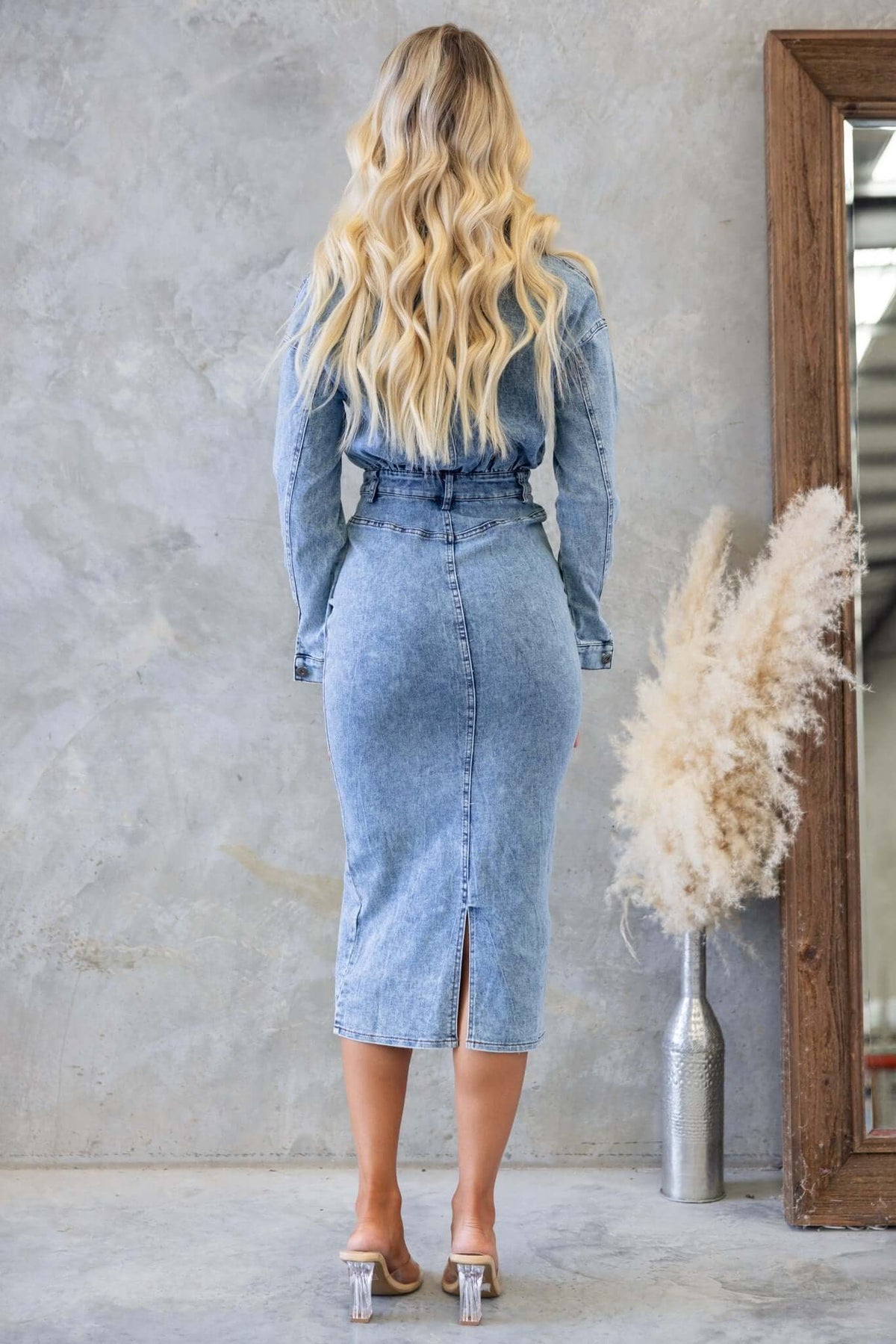 Back view of Stamford Denim Midi Dress, featuring a button-up style, split detail, and pockets, worn by a model.