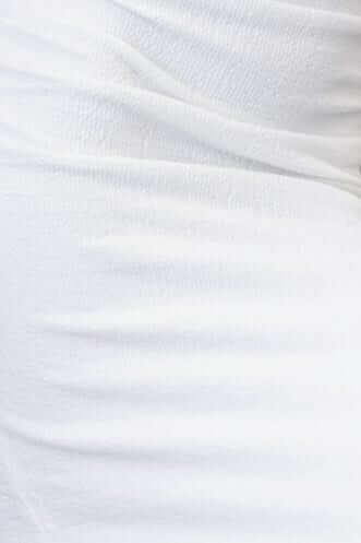 Close-up of textured white fabric showcasing ruching detail from the Topeka Midi Dress.