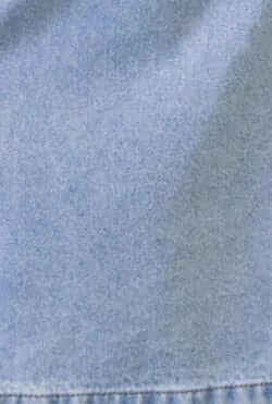 Close-up of light blue denim fabric, showcasing texture and color for the Soma Denim Midi Skirt.