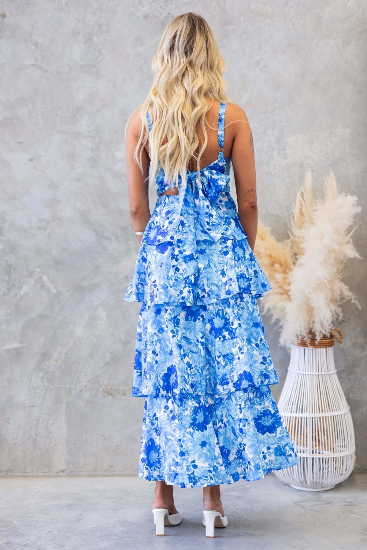 Back view of Peyton Maxi Dress in blue floral print with ruffle tiers and adjustable straps.
