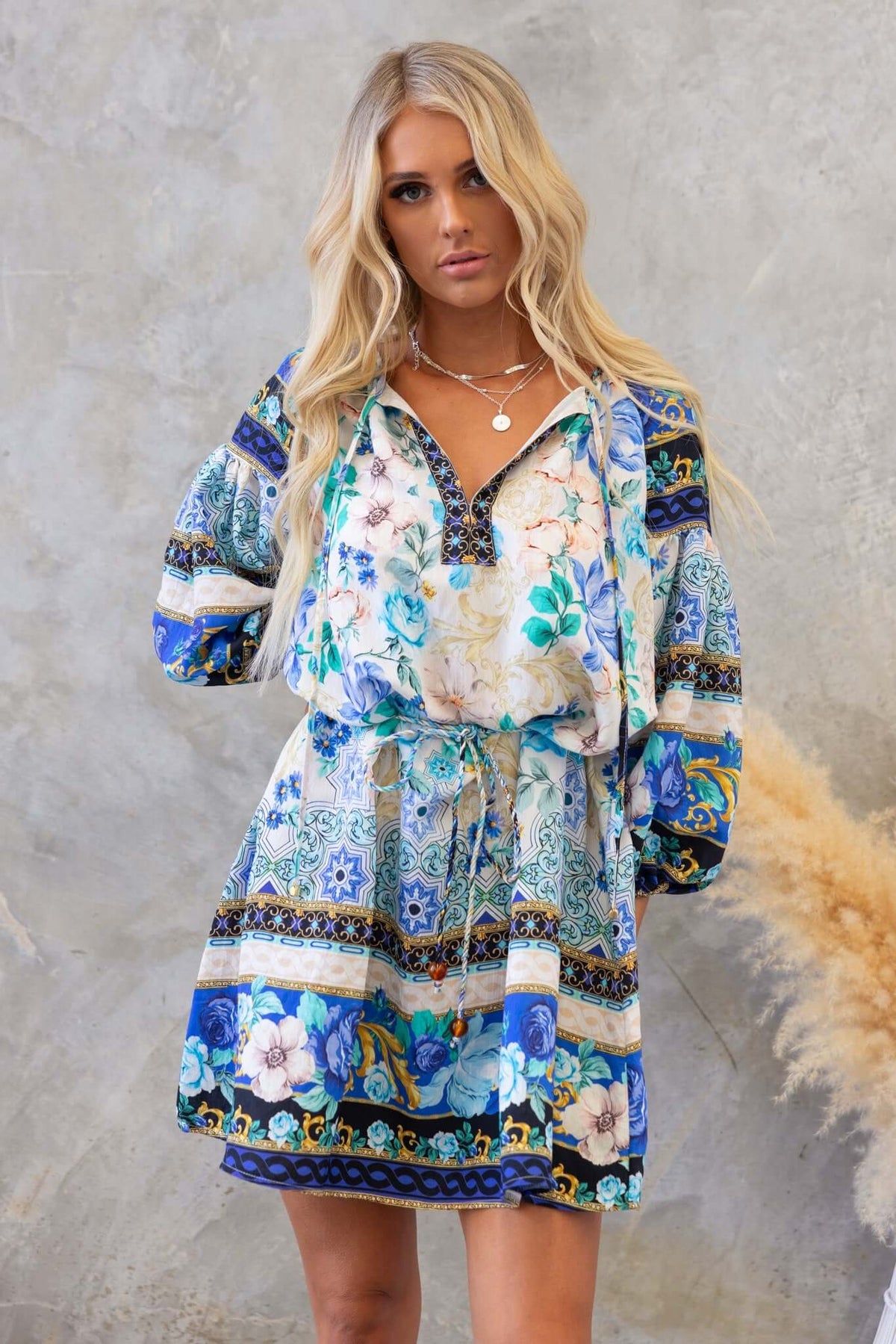 Barret Dress featuring a colorful floral print, V-neckline, and tie detail, perfect for a relaxed summer look.