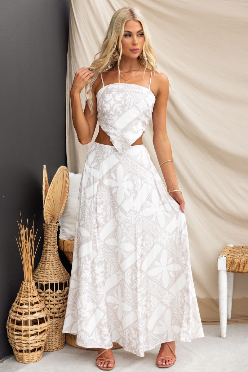 Model wearing a white Kona top with adjustable straps and a flowy skirt, showcasing a stylish and elegant summer outfit.