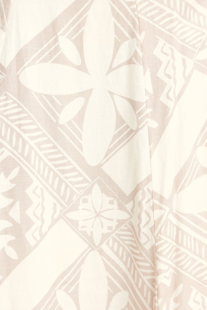Close-up of a cotton blend fabric with intricate geometric patterns in soft neutral tones for the Kona top.