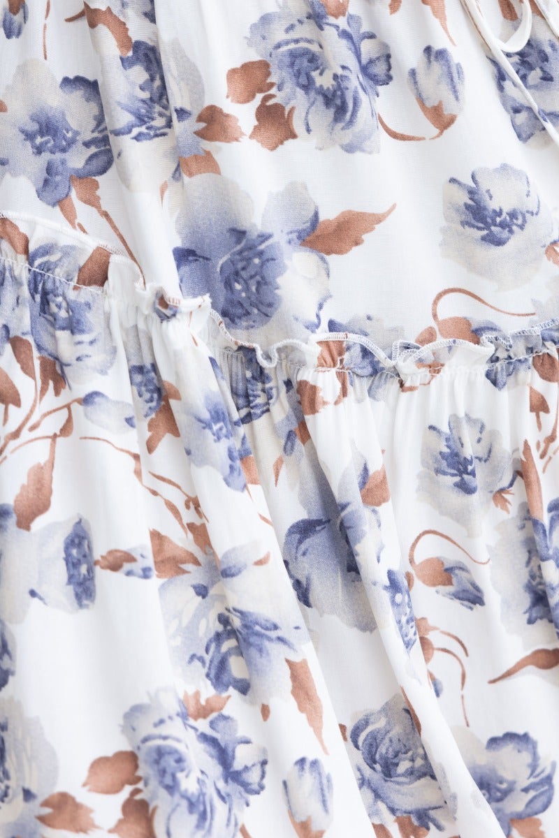 Close-up of floral print fabric with blue and beige flowers on the Last Time Dress, showcasing its delicate design.