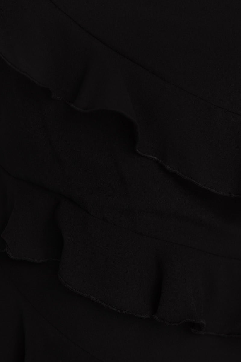 Close-up of black fabric with ruffle detail, showcasing texture and design of the Hands To Myself Maxi Dress.