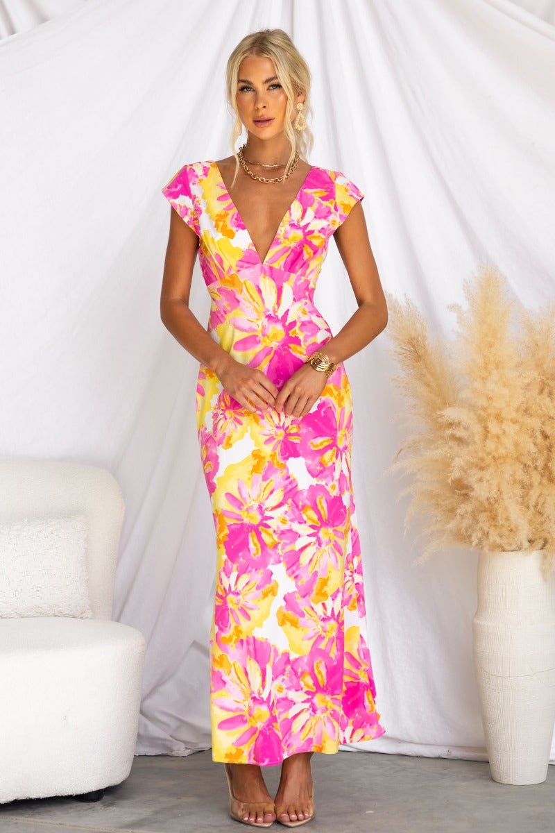 Floral print maxi dress with V-neckline and cap sleeves, featuring twist detail and cut-out back design.