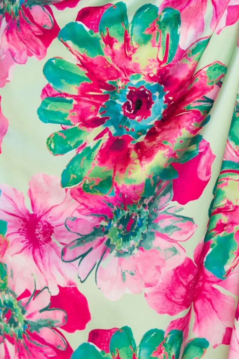 Vibrant floral print in pink and green on the Ronan Maxi Dress, showcasing bold blossoms against a soft background.