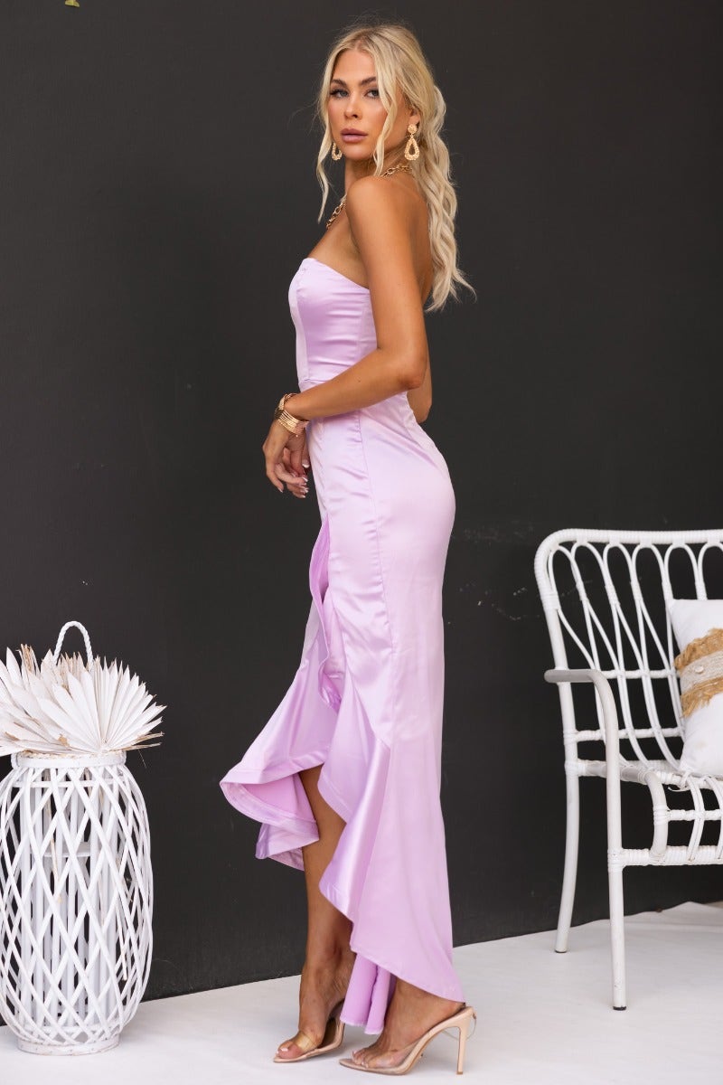 Model wearing a strapless lavender satin maxi dress with asymmetric hemline and invisible zip, styled for a chic look.