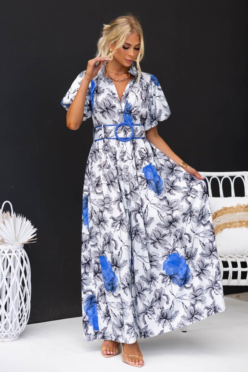 Floral print Younger Now maxi dress with high neckline, button-up front, and removable belt, modeled by a woman.