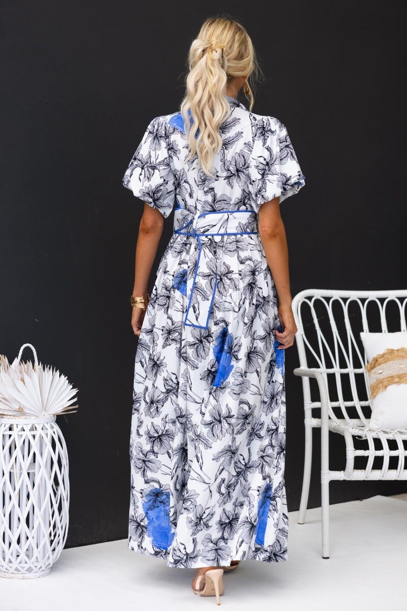 Back view of the Younger Now Maxi Dress featuring floral print, elastic sleeves, and a removable belt.
