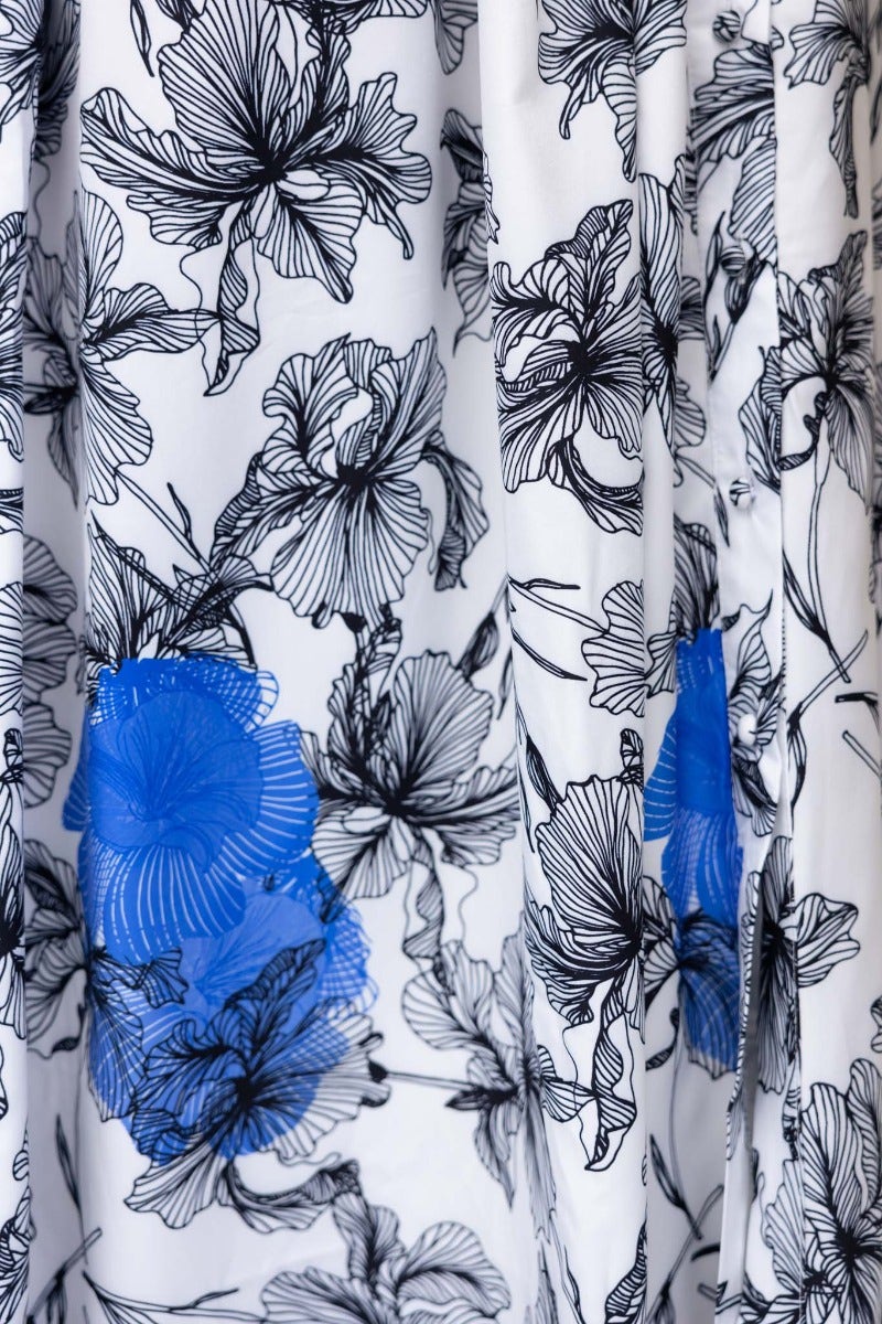 Floral print fabric detail of the Younger Now Maxi Dress featuring black and blue flowers on a white background.