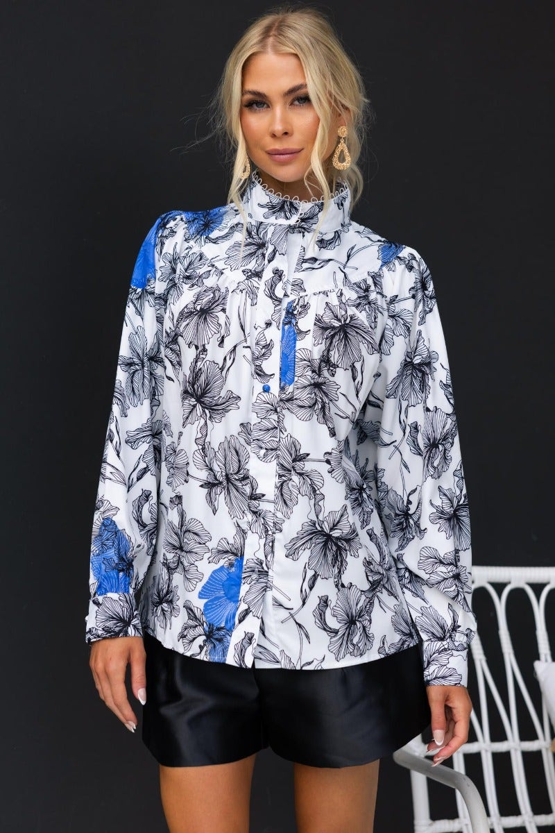 Model wearing Anaya floral print shirt with high neckline and button-up front, styled with black shorts.