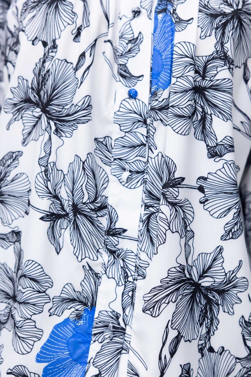 Floral print Anaya shirt featuring a high neckline and blue floral accents on a white background.