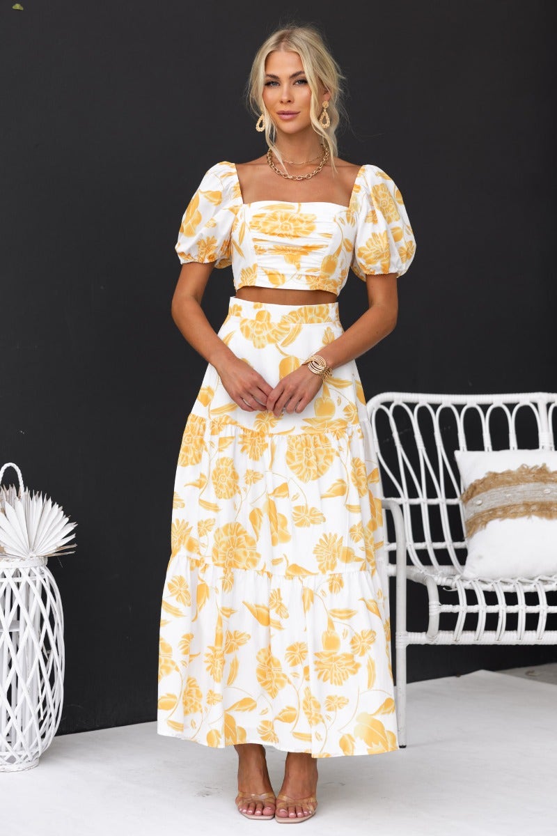 Floral print Somebody To Love set featuring a cropped top and maxi skirt in yellow and white, styled with an elegant look.