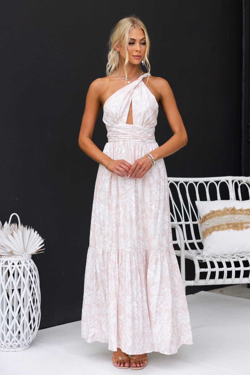 Model wearing Oakland Maxi Dress with floral print and one-shoulder neckline, stylish cut-out and layered skirt.
