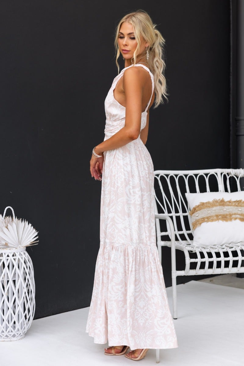 Elegant Oakland Maxi Dress featuring a floral print, one-shoulder neckline, and cut-out at bust, styled for a chic look.