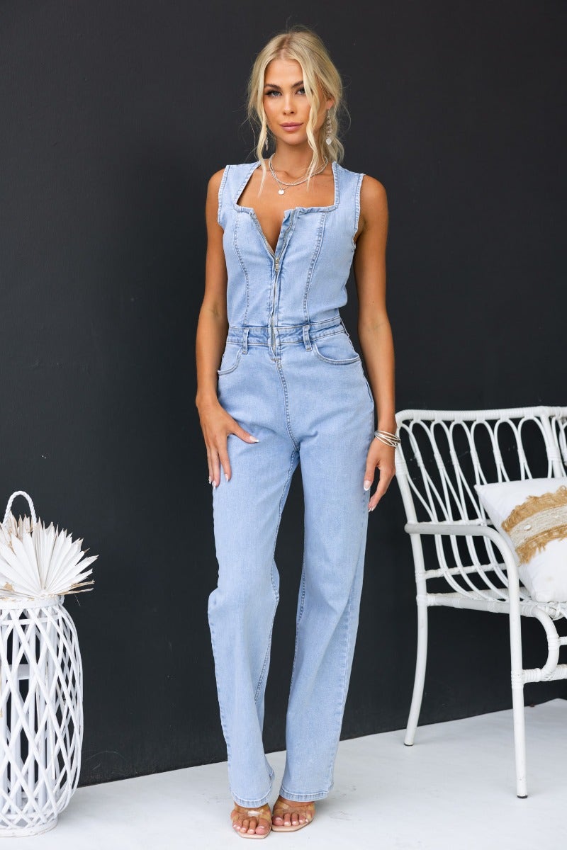 Styled photo of a model in a Kentwell denim jumpsuit featuring zip-up front and pockets, showcasing a trendy casual look.